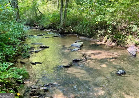 a backyard of a house with yard and outdoor seating