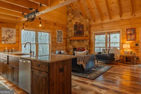 a living room with furniture a flat screen tv and a floor to ceiling window