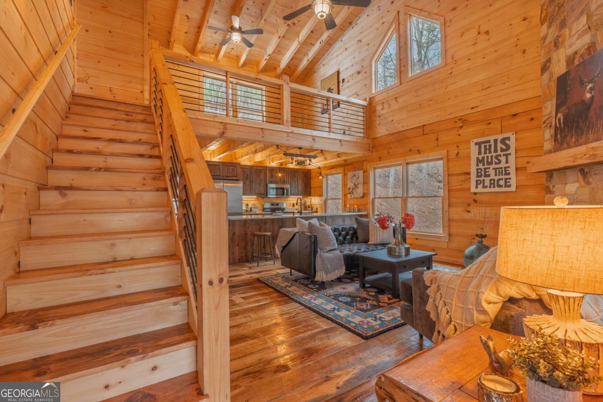 138 Rhondas Way, Unit 106 Ellijay, GA 30540 - Photo 10 of 26 a view of a patio with couches chairs and wooden floor