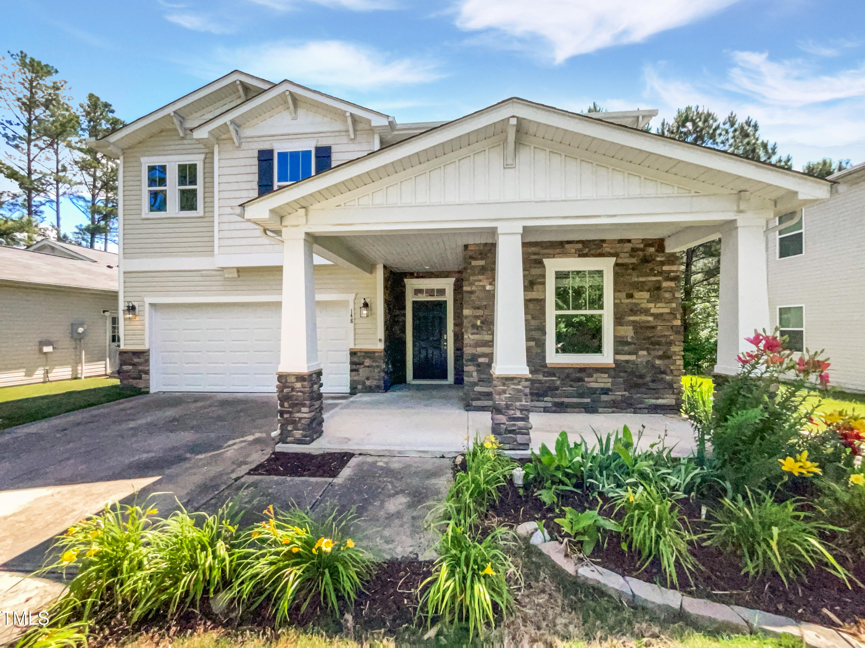 a front view of a house with garden