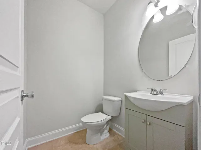 a bathroom with a sink mirror and toilet