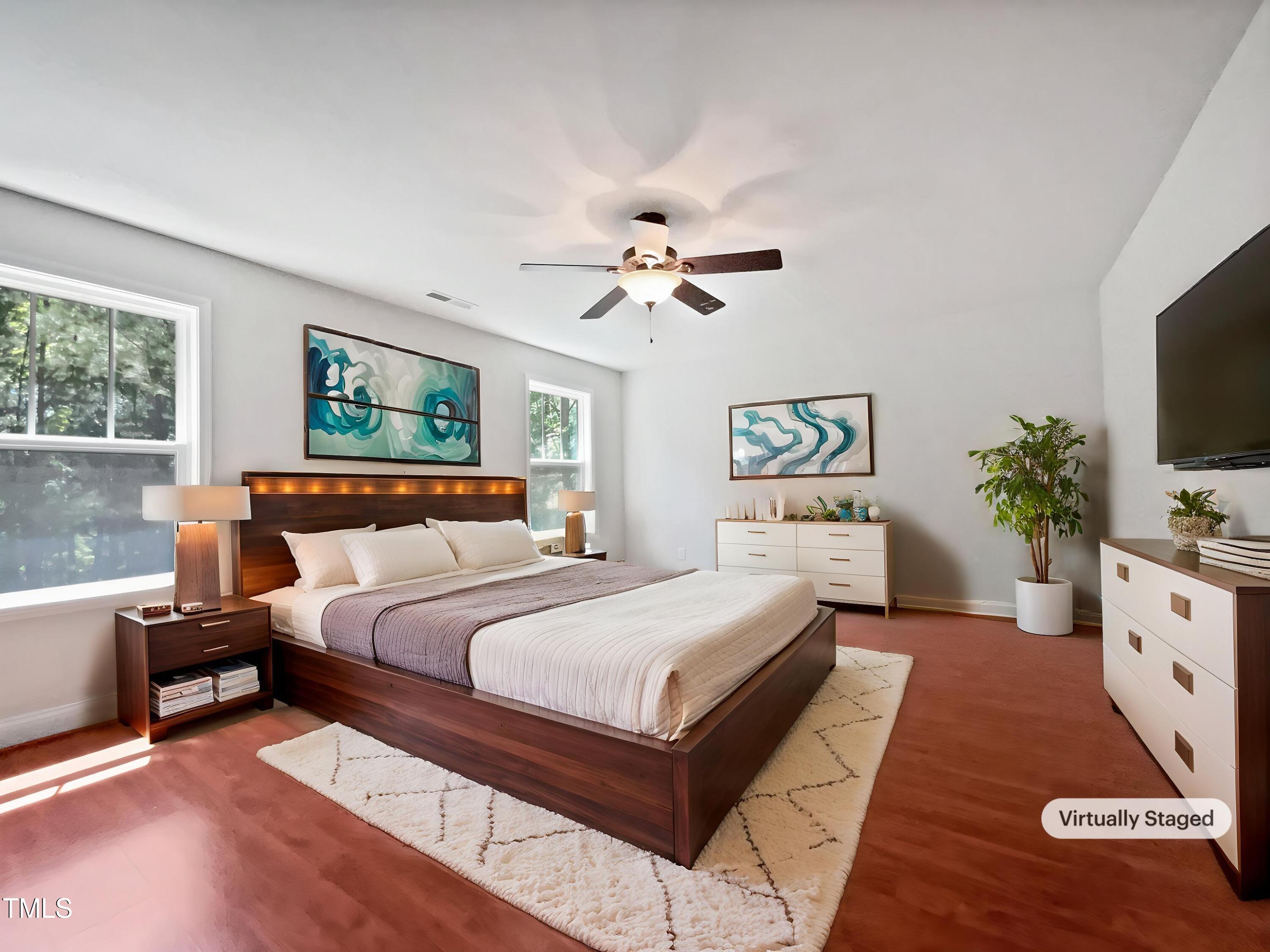 148 Daneborg Road Durham, NC 27703 - Photo 4 of 21 a bedroom with a large bed and a chandelier