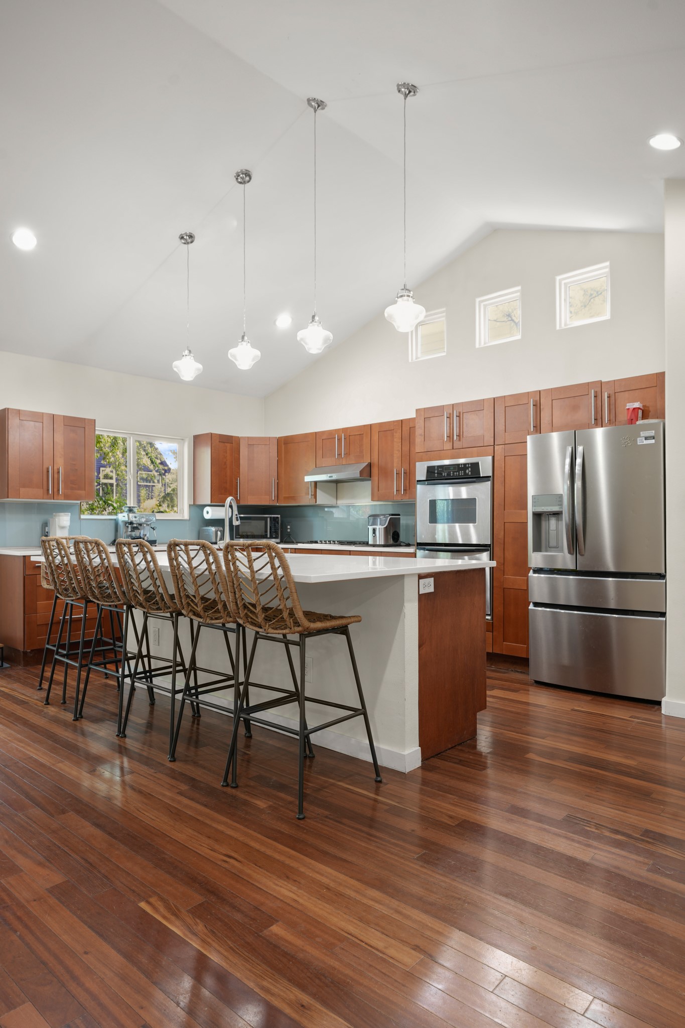 2501 Del Curto Road Austin, TX 78704 - Photo 9 of 26 Rich hardwood floors complement warm cabinetry and vaulted ceilings in this spacious kitchen.