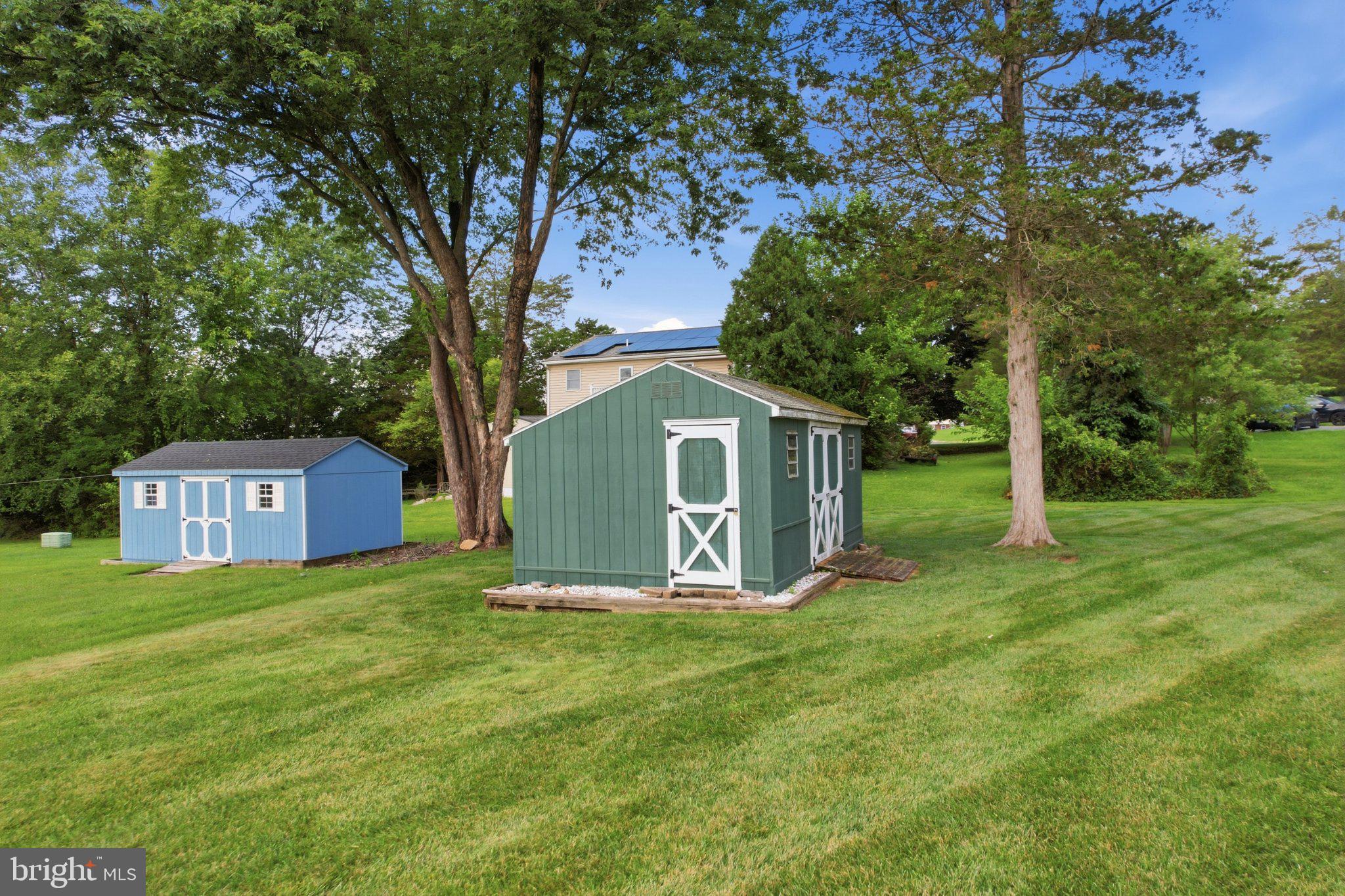 1385 Woodmere Road Pottstown, PA 19464 - Photo 52 of 63 Charming sheds in a lush green setting.