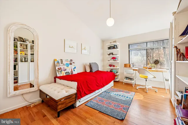 a living room with furniture a rug and a window