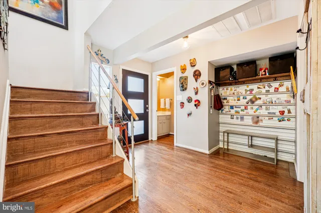 a view of entryway with wooden floor and stairs