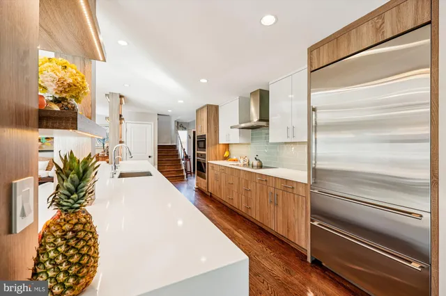 a kitchen with counter top space and wooden floor