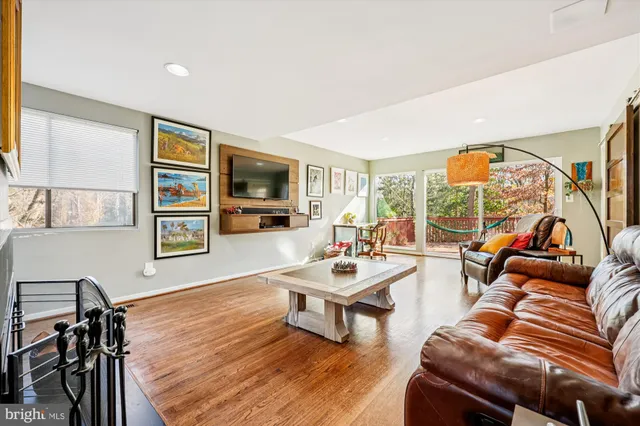 a living room with furniture a rug and a flat screen tv