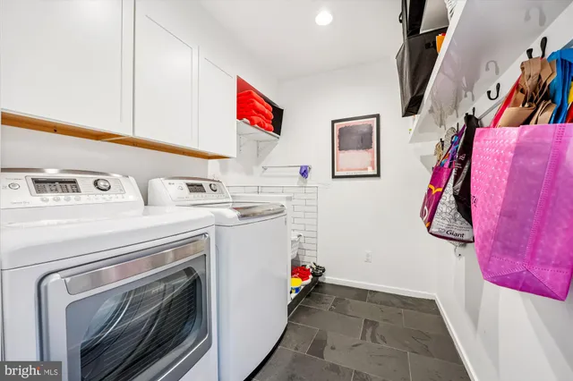 a bedroom with a bed and a large window with wooden floor