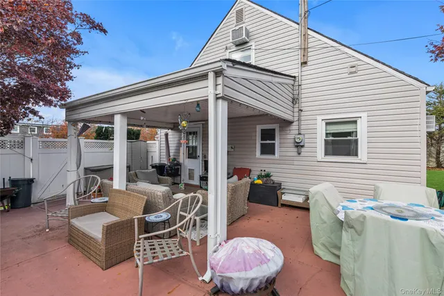a view of a patio with couches table and chairs and potted plants