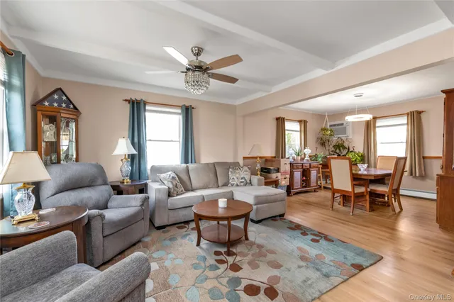 a living room with furniture a dining table a lamp and a window