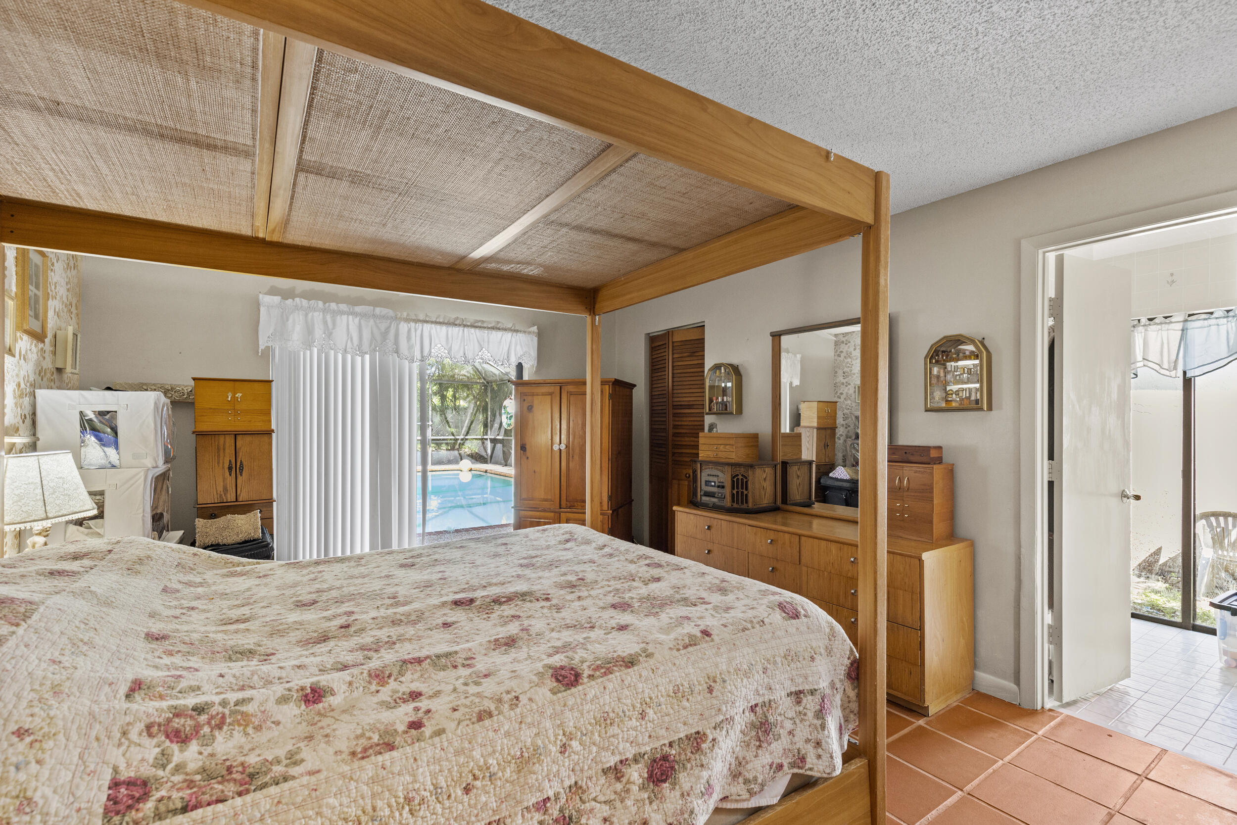 21665 Sutters Lane Boca Raton, FL 33428 - Photo 18 of 42 a bedroom with a large bed and dresser
