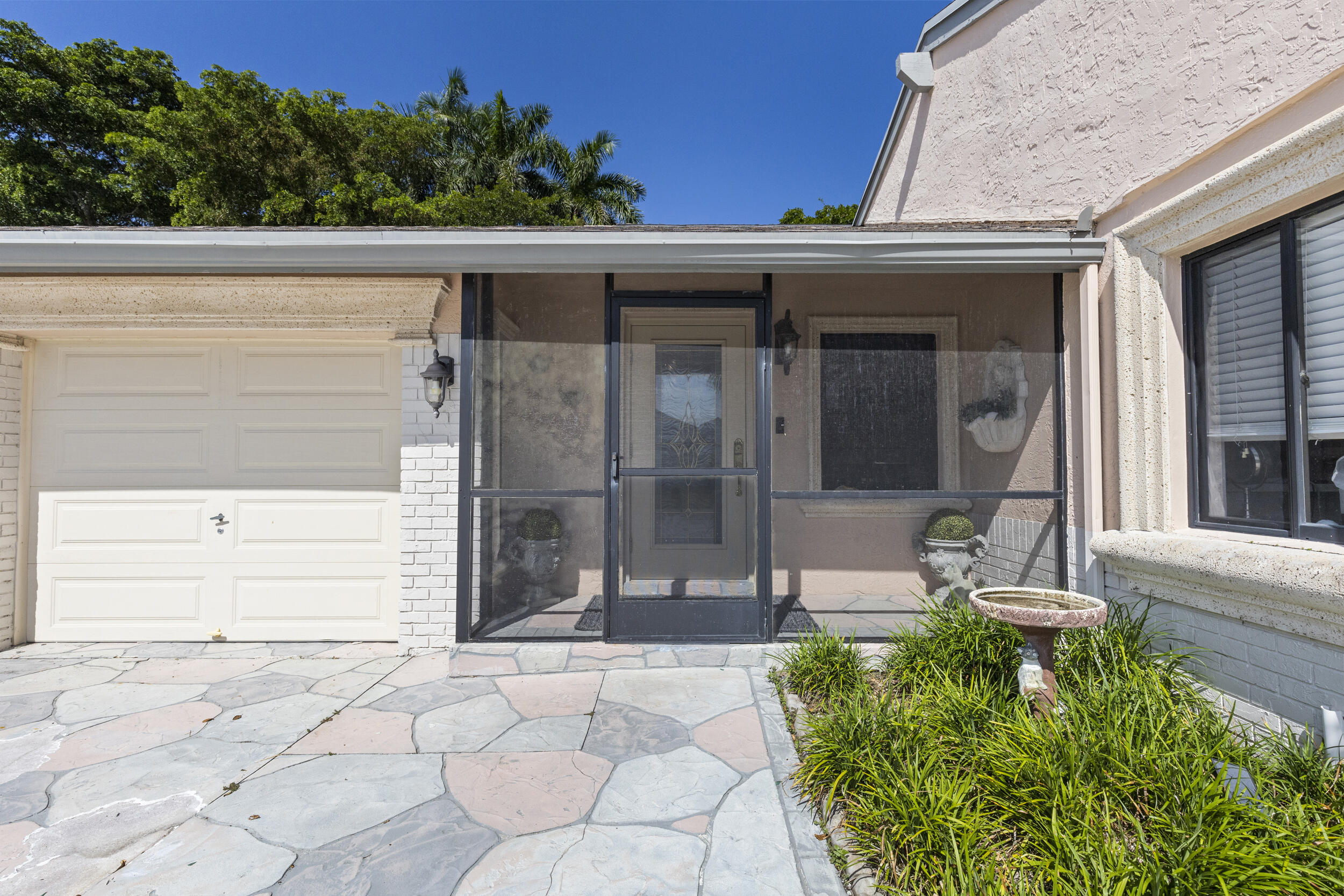 21665 Sutters Lane Boca Raton, FL 33428 - Photo 3 of 42 a front view of a house with a garden