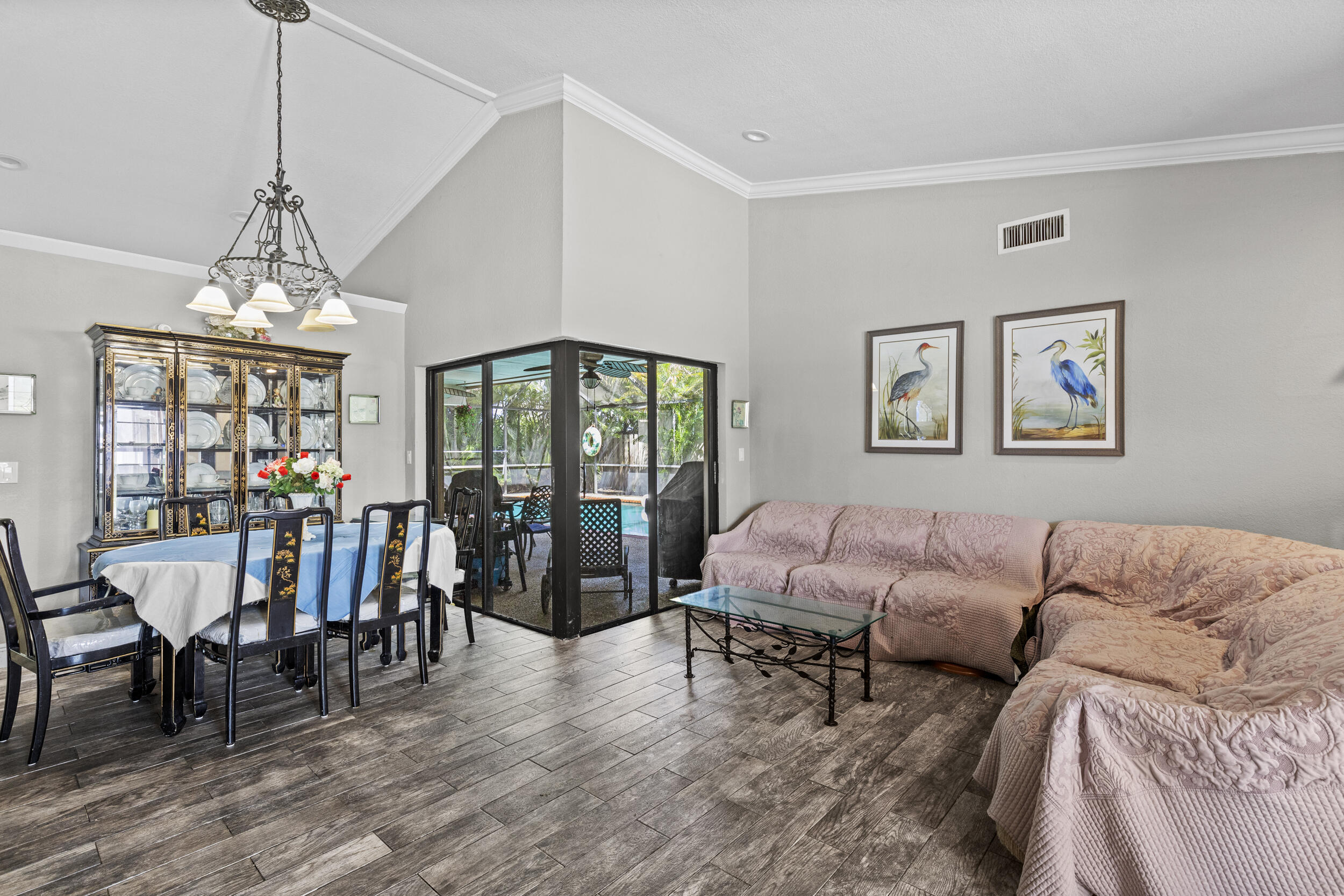 21665 Sutters Lane Boca Raton, FL 33428 - Photo 5 of 42 a living room with furniture dining table and a chandelier