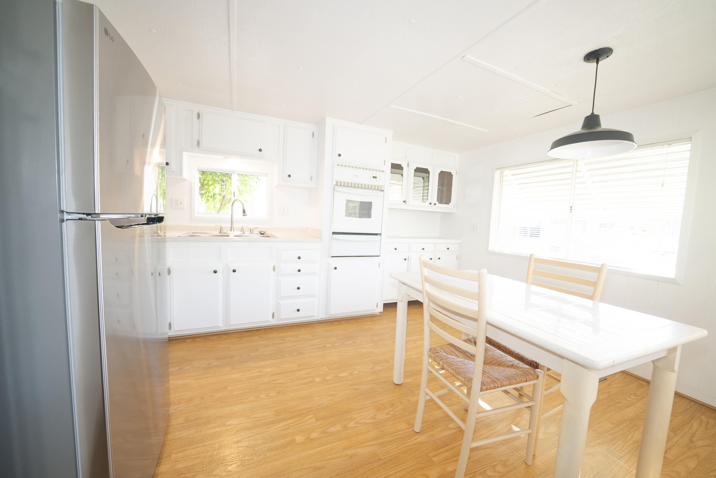 4025 State Street, Unit 26 Santa Barbara, CA 93110 - Photo 9 of 20 a kitchen with stainless steel appliances cabinets and wooden floor