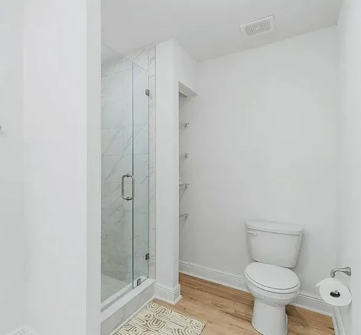 a bathroom with a shower and a sink