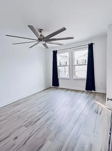 an empty room with wooden floor and closet