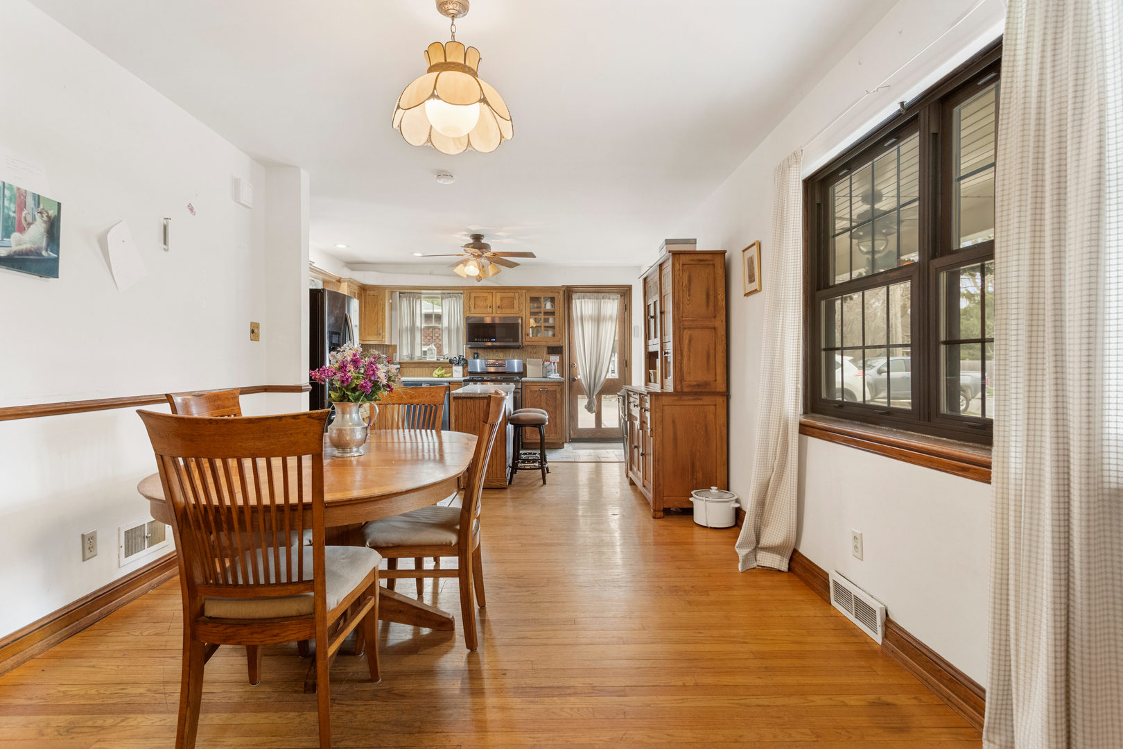 901 West Green Street Champaign, IL 61821 - Photo 11 of 36 a view of a dining room with furniture wooden floor and chandelier