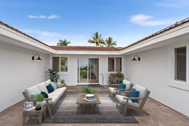 a view of a house with backyard sitting area and furniture