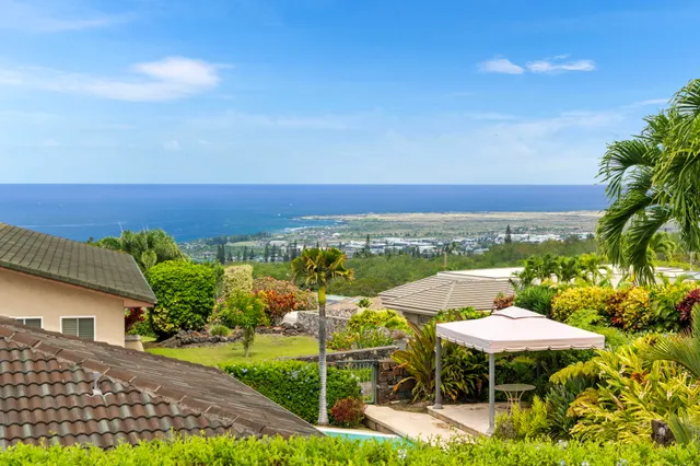 a view of a patio with furniture and garden