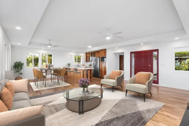 a living room with furniture and wooden floor