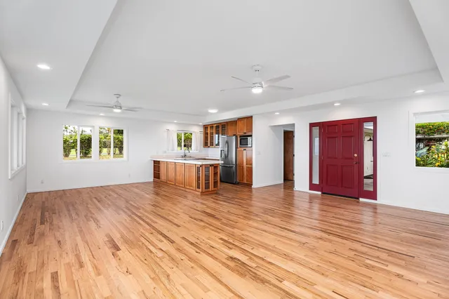 a view of a livingroom with wooden floor and windows