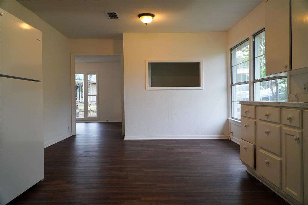 403 North Fairview Street Keene, TX 76059 - Photo 14 of 25 an empty room with wooden floor and windows