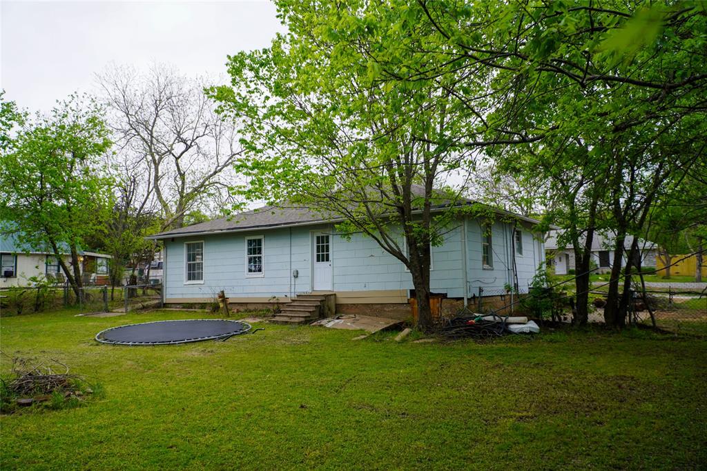 403 North Fairview Street Keene, TX 76059 - Photo 25 of 25 a view of a backyard with a garden and trees