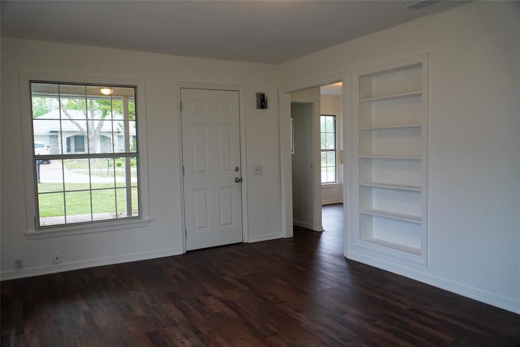 403 North Fairview Street Keene, TX 76059 - Photo 9 of 25 an empty room with wooden floor closet and windows