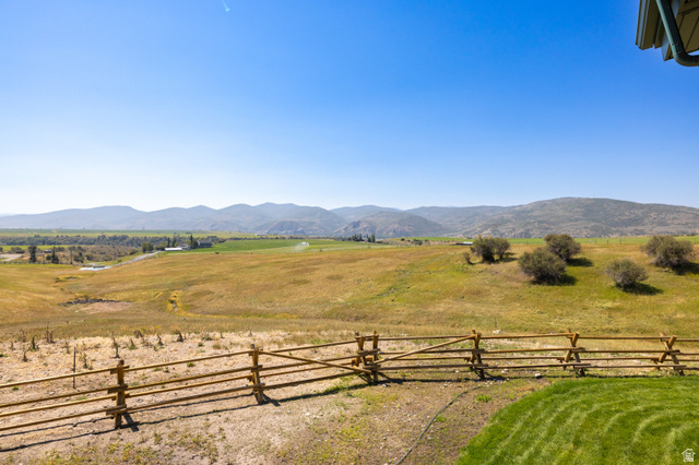 6117 North Rocky Ridge Road Peoa, UT 84061 - Photo 9 of 82 Expansive rural landscape featuring distant mountains, fields, and a split-rail fence