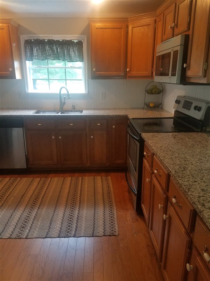 45 River Rdg Road Verona, VA 24482 - Photo 4 of 21 a kitchen with wooden cabinets and a sink