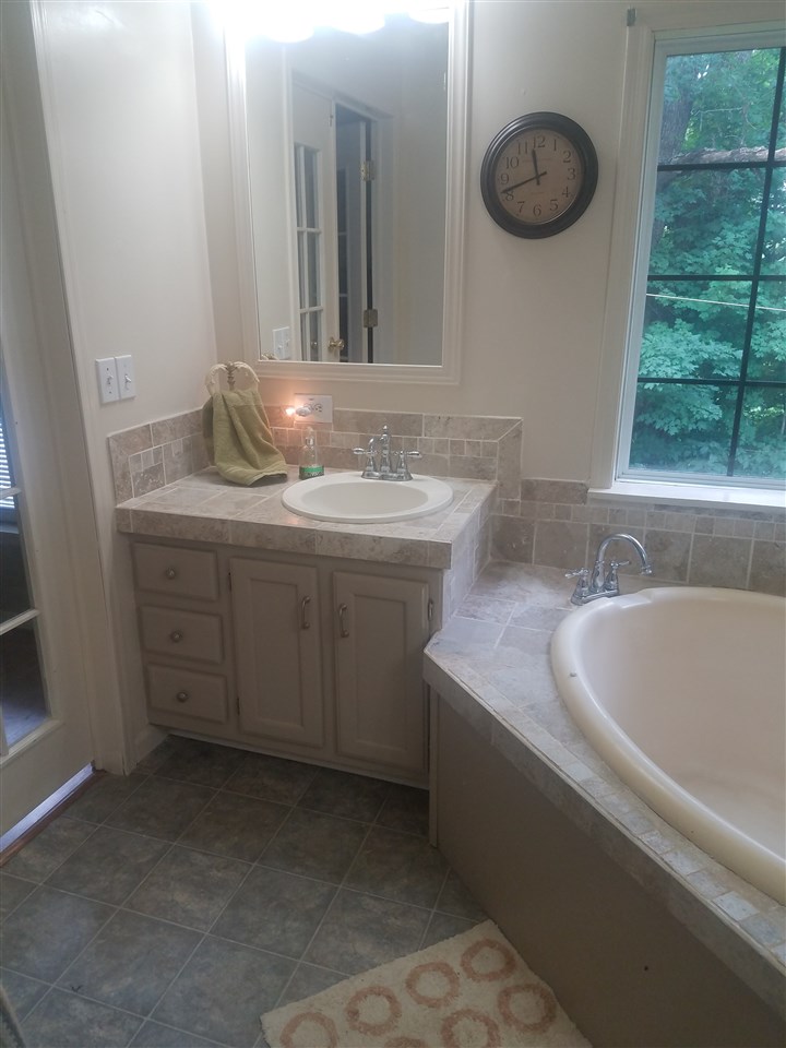45 River Rdg Road Verona, VA 24482 - Photo 9 of 21 a bathroom with a granite countertop sink and a bathtub