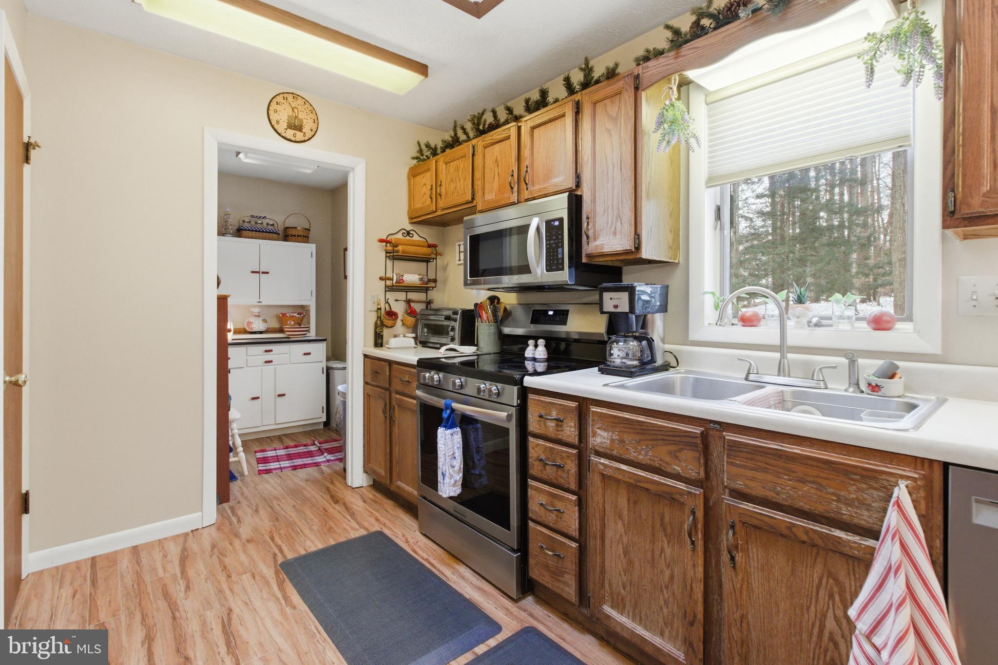 63 Sea Horse Road Du Bois, PA 15801 - Photo 20 of 35 a kitchen with stainless steel appliances granite countertop a sink cabinets and a wooden floor