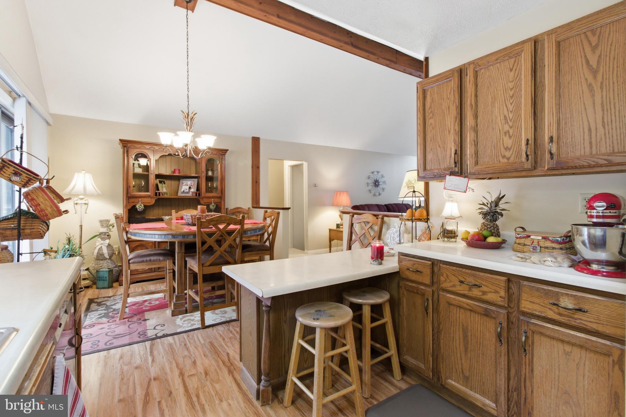 63 Sea Horse Road Du Bois, PA 15801 - Photo 23 of 35 a open kitchen with stainless steel appliances kitchen island granite countertop a table chairs and a wooden floor