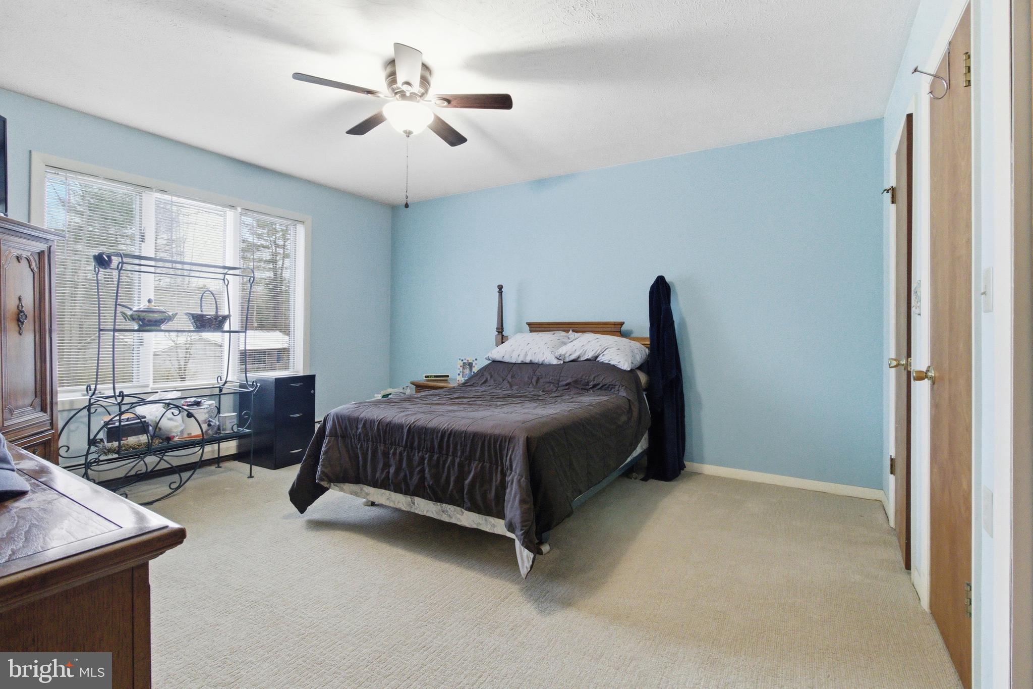 63 Sea Horse Road Du Bois, PA 15801 - Photo 25 of 35 a spacious bedroom with a bed and a chandelier