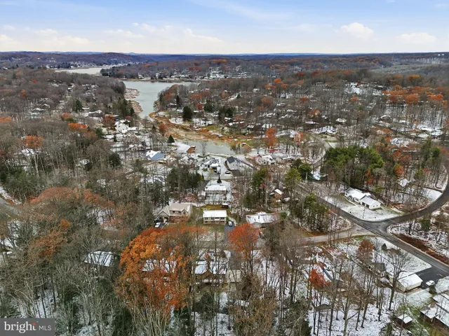 an aerial view of a house with garden space and street view