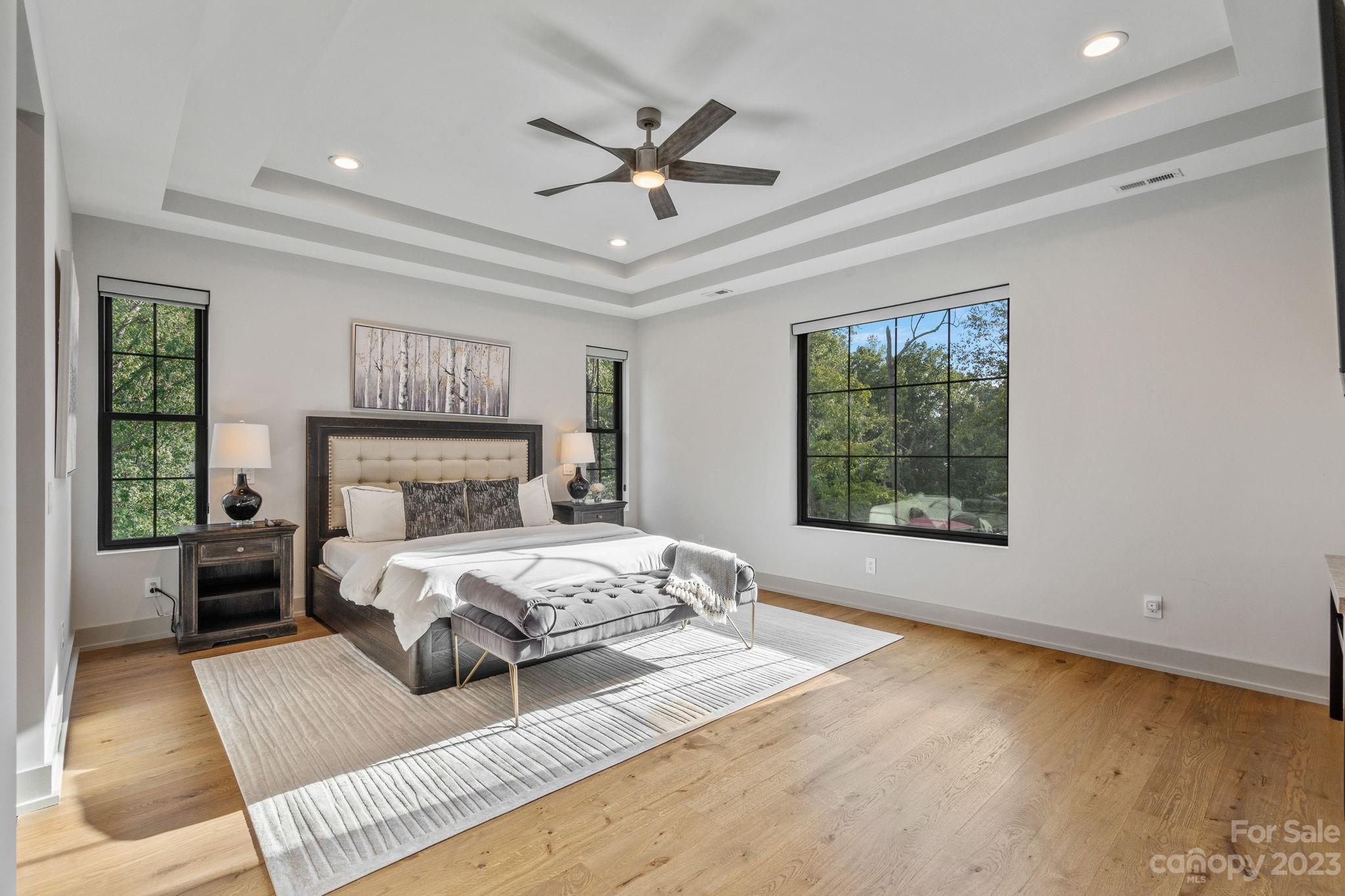 222 Greenbay Road Mooresville, NC 28117 - Photo 26 of 44 a bedroom with a large bed chandelier and a window