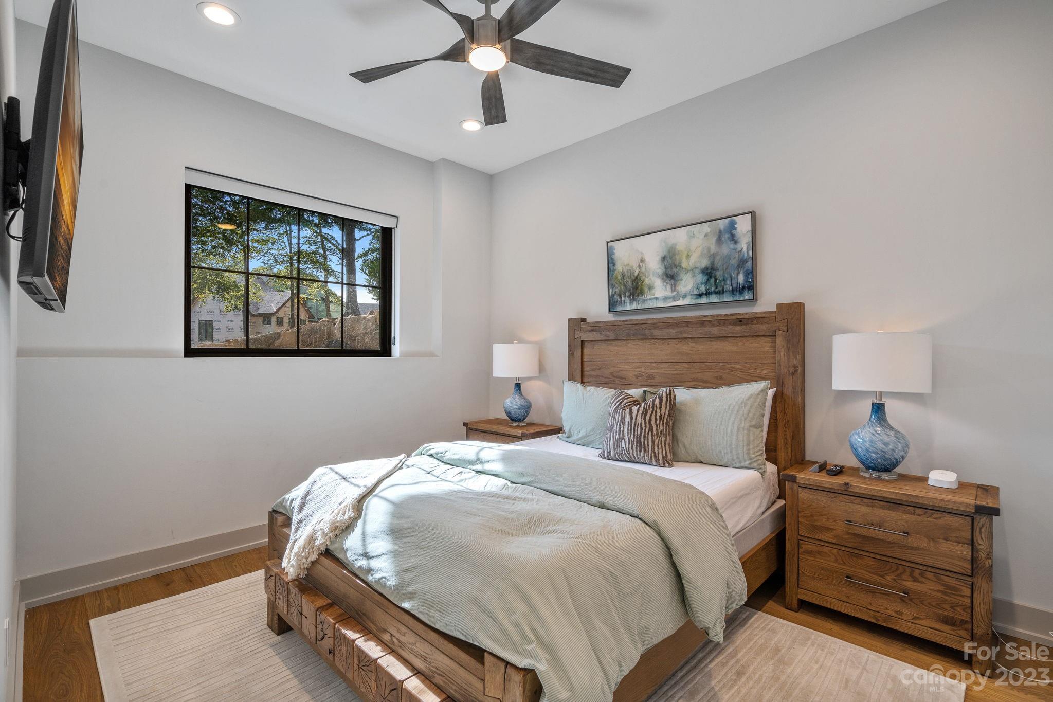 222 Greenbay Road Mooresville, NC 28117 - Photo 35 of 44 a bedroom with a bed and a chandelier