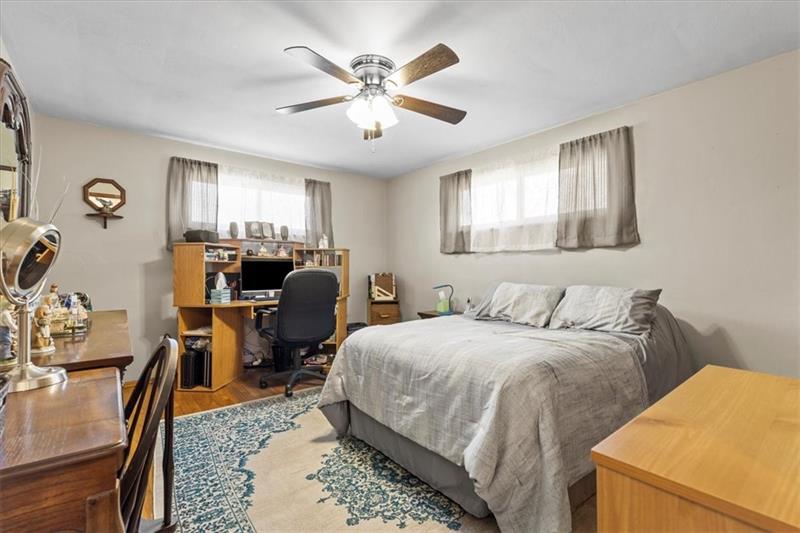 13733 Ormsby Drive Irwin, PA 15642 - Photo 12 of 24 a bedroom with a bed and a chandelier