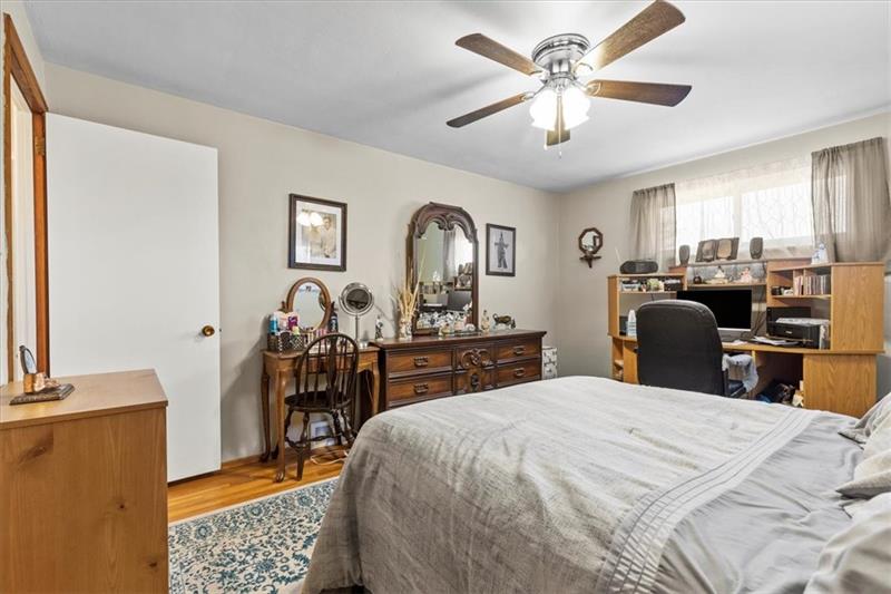 13733 Ormsby Drive Irwin, PA 15642 - Photo 13 of 24 a bedroom with a bed and a chandelier