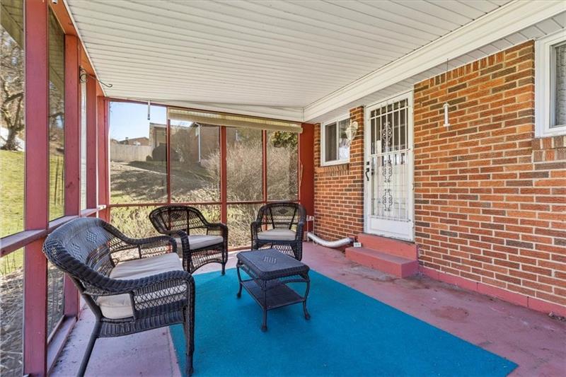 13733 Ormsby Drive Irwin, PA 15642 - Photo 22 of 24 a living room with furniture and floor to ceiling window