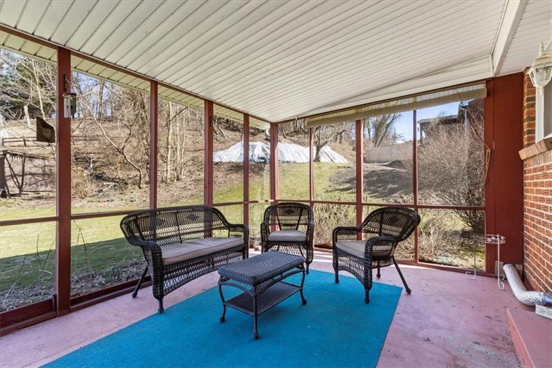 13733 Ormsby Drive Irwin, PA 15642 - Photo 23 of 24 a living room with furniture and a floor to ceiling window