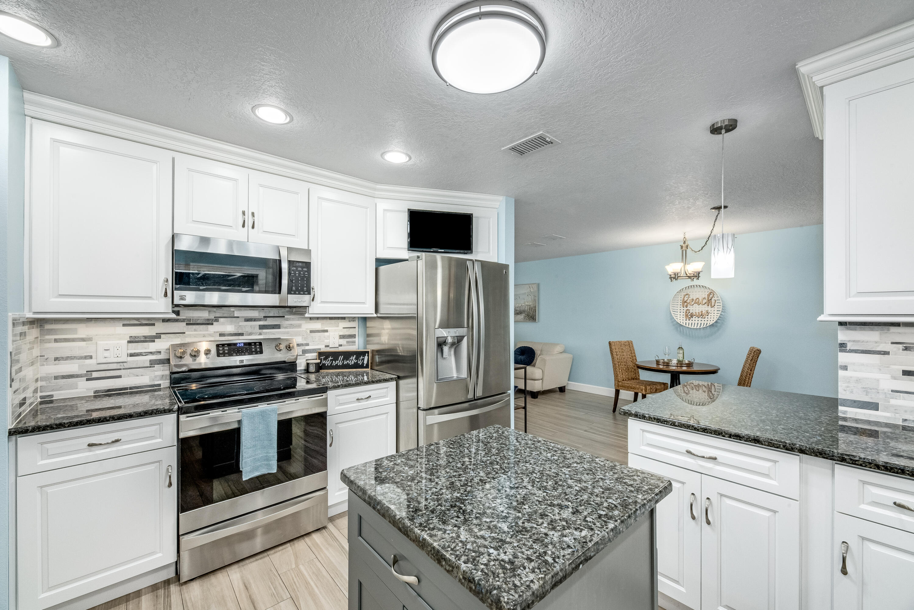 415 Wayne Avenue Indialantic, FL 32903 - Photo 15 of 63 a kitchen with stainless steel appliances granite countertop a stove oven and a refrigerator