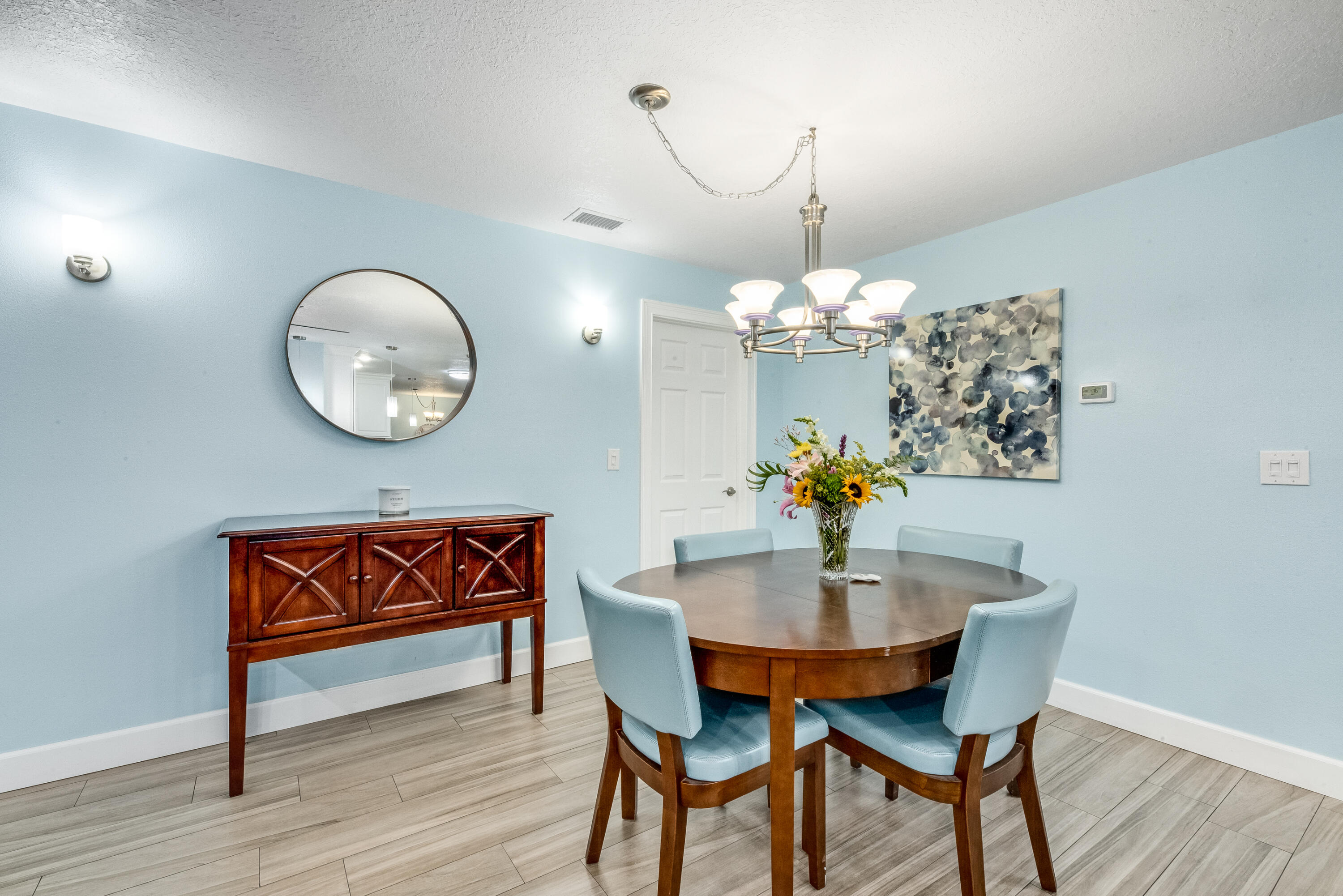 415 Wayne Avenue Indialantic, FL 32903 - Photo 18 of 63 a dining room with furniture a potted plant and wooden floor