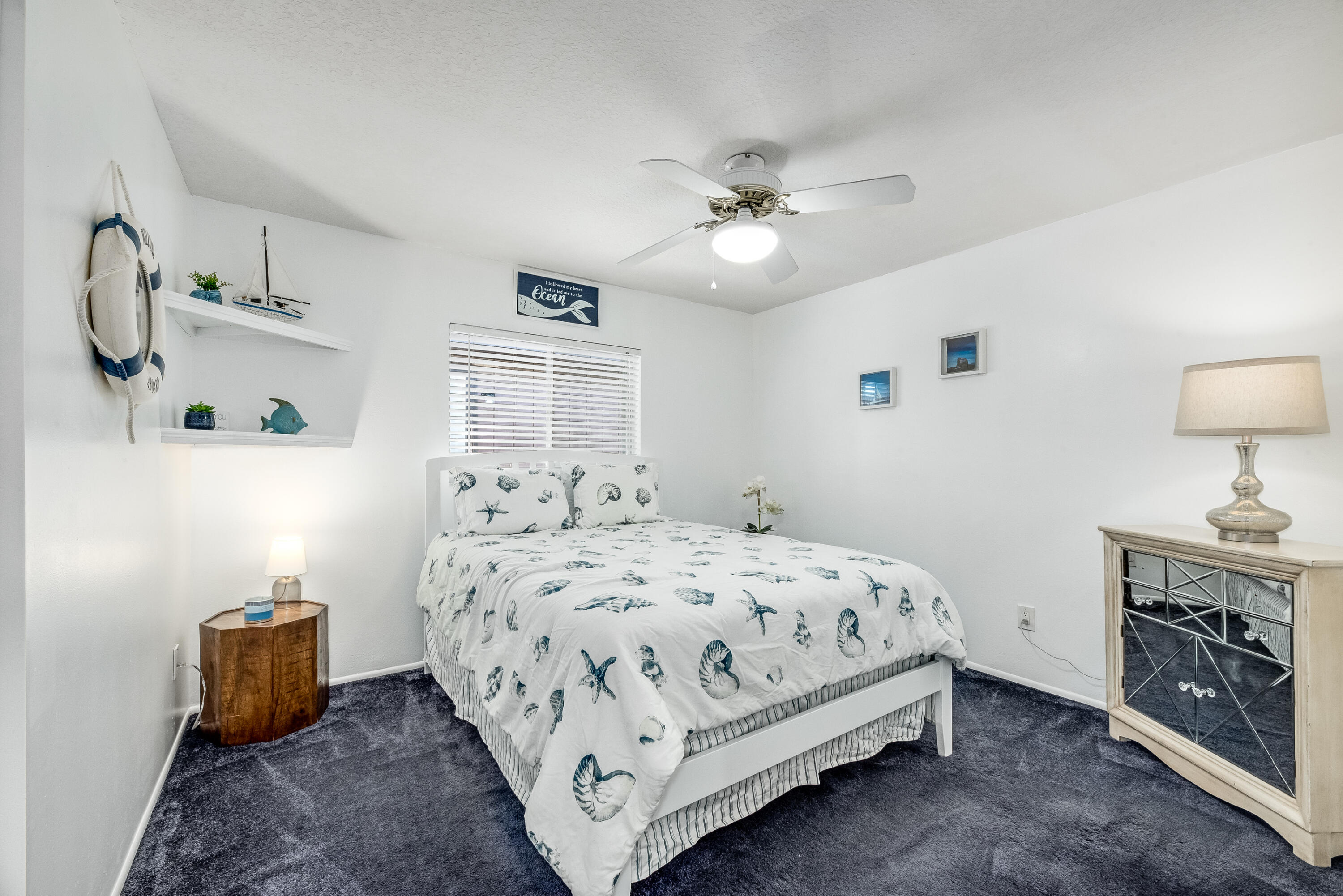 415 Wayne Avenue Indialantic, FL 32903 - Photo 24 of 63 a bedroom with a bed and a chandelier
