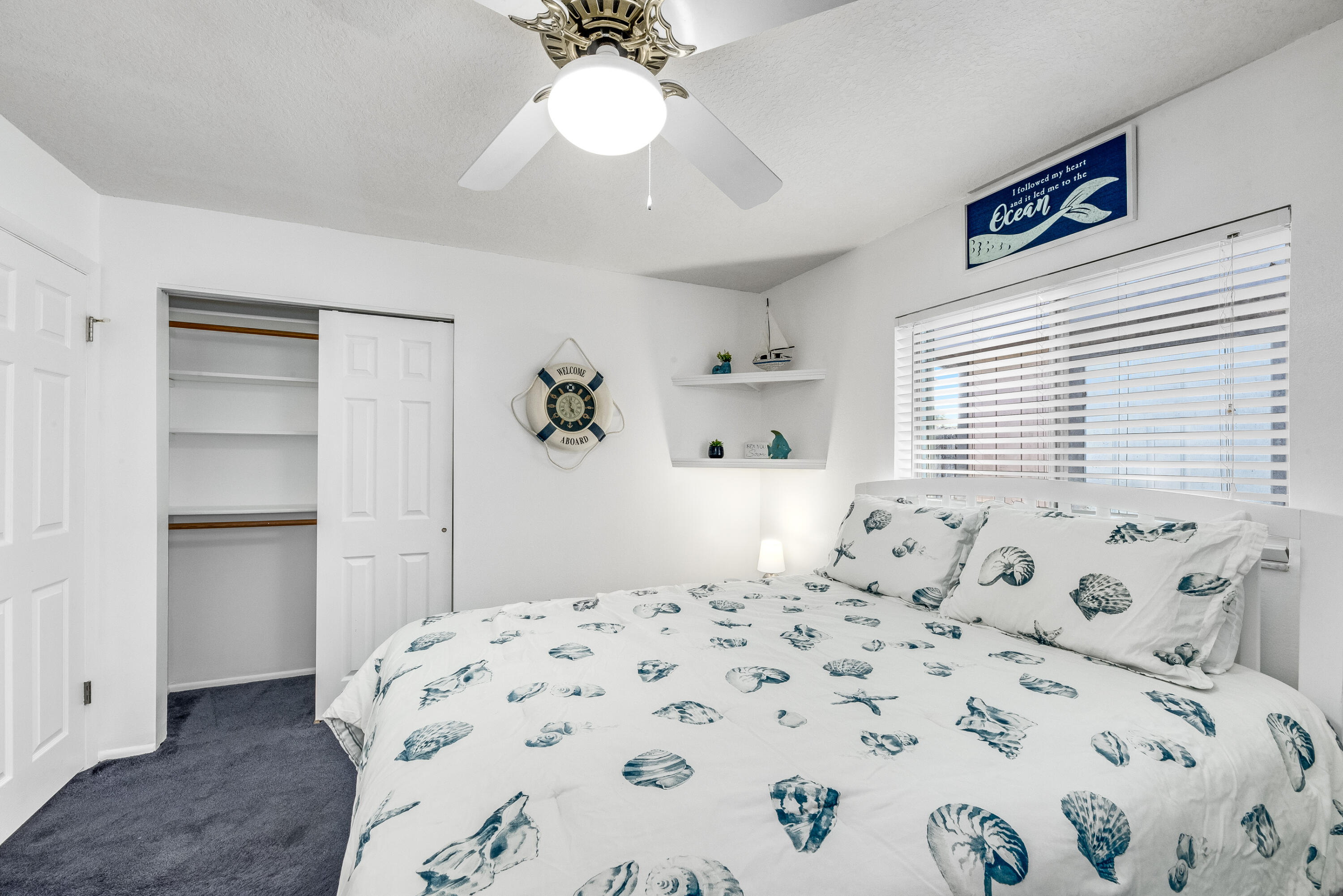 415 Wayne Avenue Indialantic, FL 32903 - Photo 25 of 63 a bedroom with a bed and a chandelier