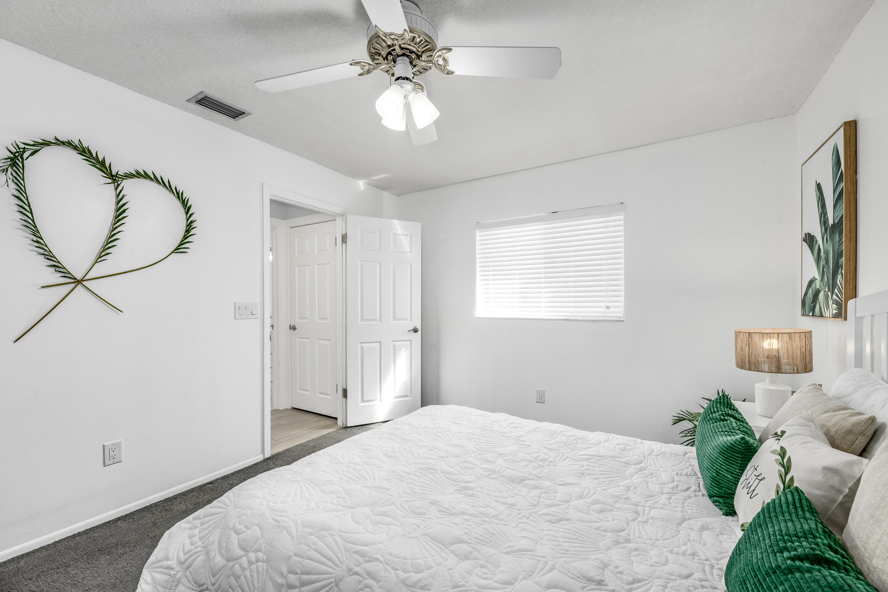 415 Wayne Avenue Indialantic, FL 32903 - Photo 28 of 63 a bedroom with a bed and a chandelier