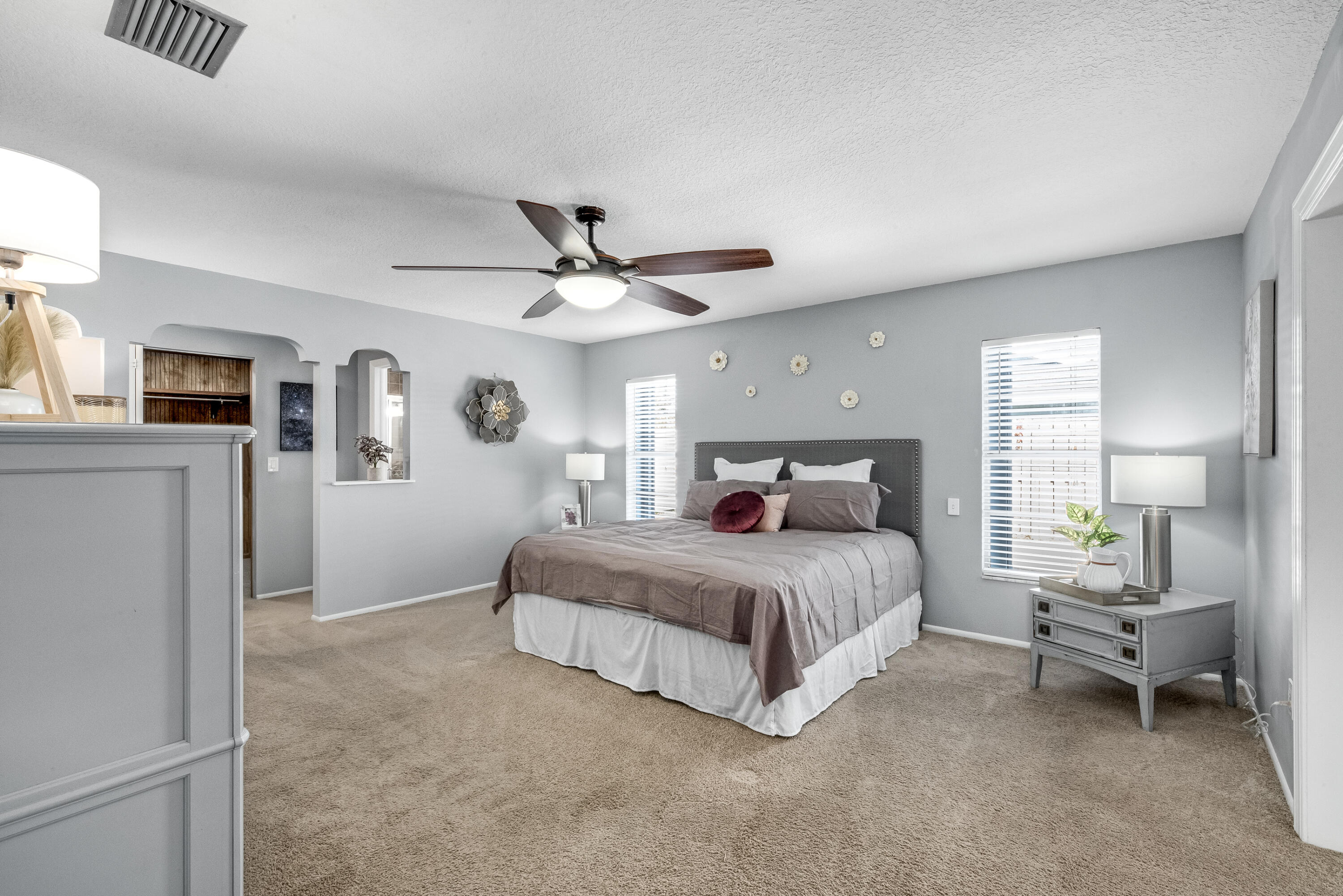 415 Wayne Avenue Indialantic, FL 32903 - Photo 41 of 63 a spacious bedroom with a bed and a chandelier