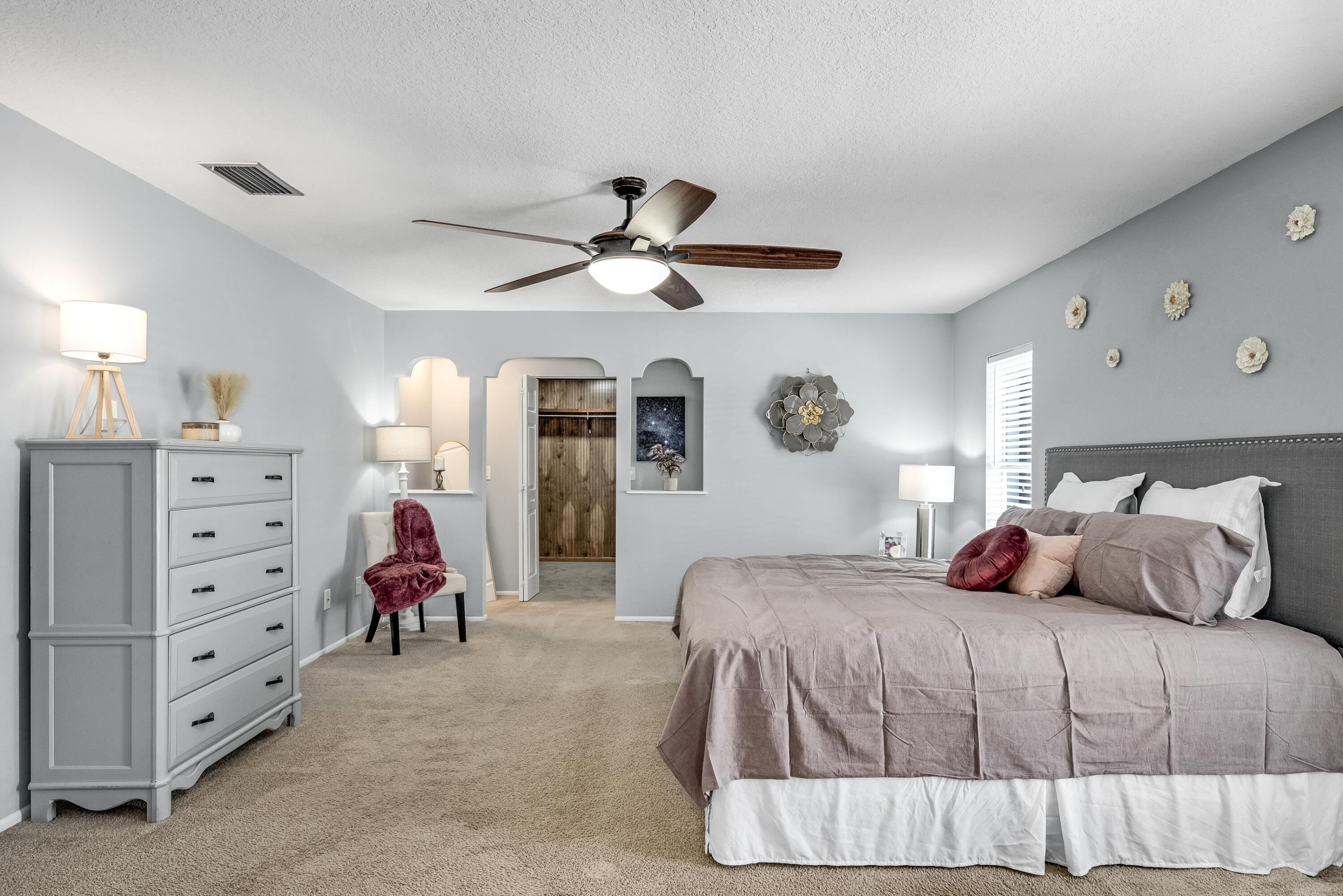415 Wayne Avenue Indialantic, FL 32903 - Photo 42 of 63 a bedroom with a bed a lamp and a chandelier
