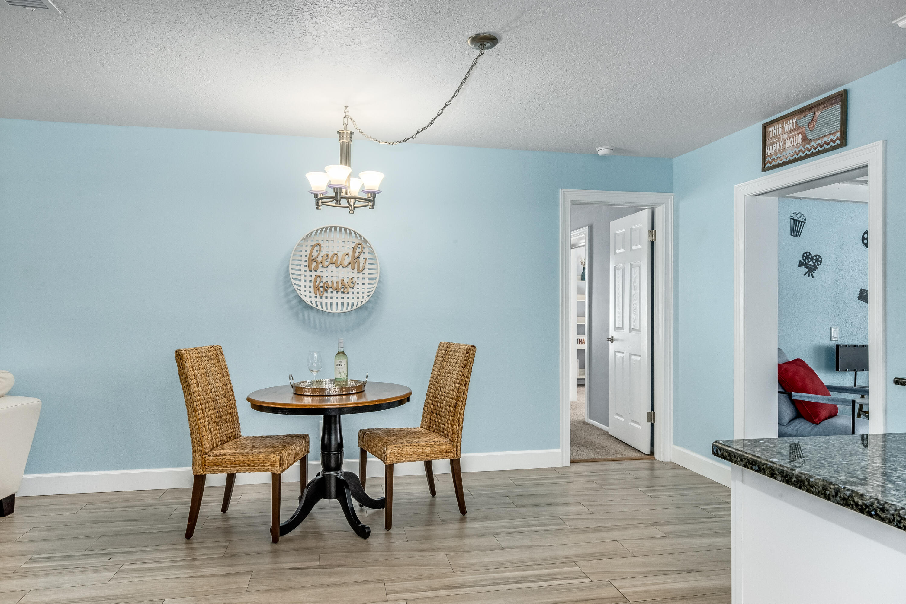 415 Wayne Avenue Indialantic, FL 32903 - Photo 9 of 63 a dining room with furniture a chandelier and wooden floor